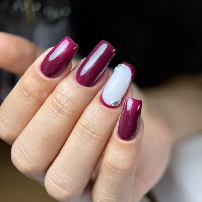 Uñas cuadradas en vino con una uña azul cielo